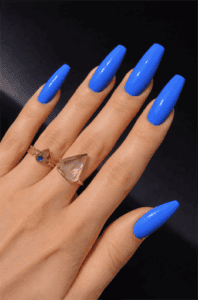 Bright cobalt blue coffin nails with glossy finish on long acrylic nails, bold solid color manicure design
