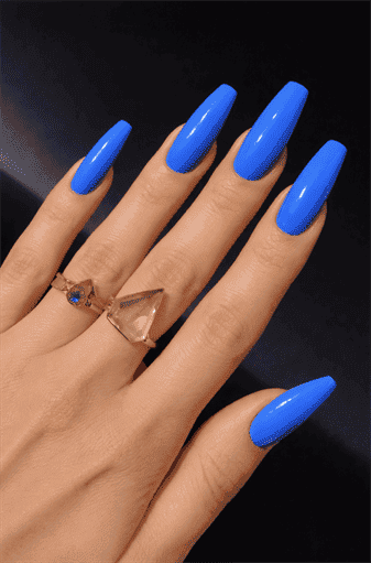 Bright cobalt blue coffin nails with glossy finish on long acrylic nails, bold solid color manicure design