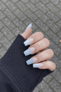 Long square ombre nails with soft white to sheer nude gradient and glossy finish, clean minimalist acrylic manicure