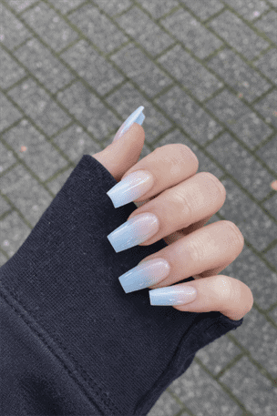 Long square ombre nails with soft white to sheer nude gradient and glossy finish, clean minimalist acrylic manicure