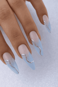 Light blue ombre almond nails with nude base and silver chrome wave accents, glossy modern minimalist nail design