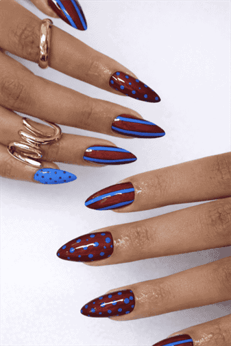 Brown and blue abstract almond nails with glossy finish featuring polka dots and striped nail art design on long nails