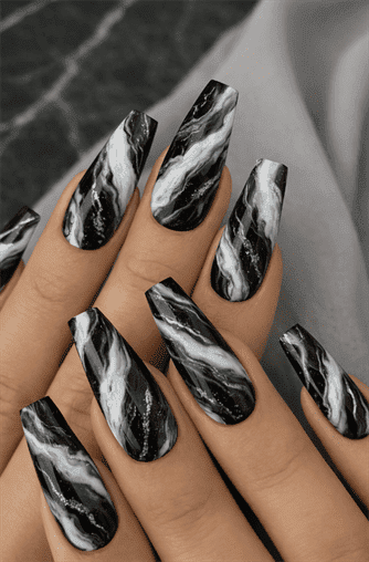 Long coffin-shaped nails with black and white marble swirl design, high-gloss finish, bold contrast pattern on sleek modern statement nails