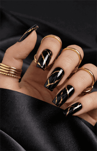 Coffin-shaped black nails with gold foil marble detailing, glossy luxury finish with abstract veining, bold high-end statement nail design