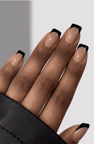 Short square nails with nude base and classic black French tips, clean minimalist design with glossy finish and timeless modern aesthetic