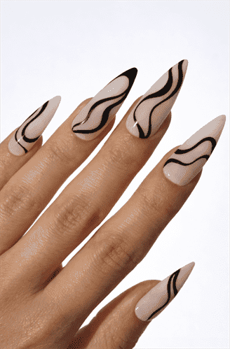 Long almond nails with nude base and flowing black abstract wave lines, minimalist modern design with glossy finish and soft neutral tones