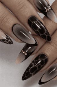 Long almond nails with smoky black ombre and tortoiseshell pattern, glossy layered effect with rich depth and luxury gradient design