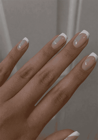 Short square nails with nude pink base and crisp white French tips, glossy finish with timeless clean classic manicure style