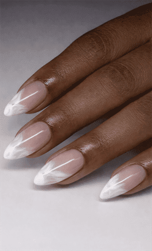 Almond-shaped nails with nude base and white marble French tips, glossy finish with delicate veining detail and elevated minimalist design