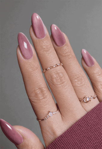 Almond-shaped nails with dusty rose chrome cat eye effect, magnetic shimmer finish with reflective depth and sleek metallic gradient nail design