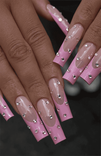 Long square nails with pink French tips over nude base, embellished with rhinestones for added sparkle, glossy finish with bold glam statement design