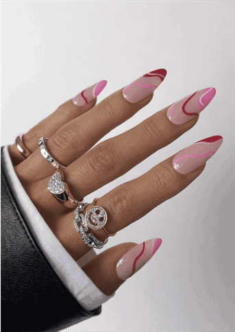 Almond-shaped nails with nude base and flowing pink and red wave French tips, abstract swirl design with glossy finish and modern artistic aesthetic