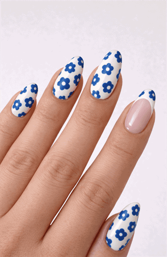 Almond-shaped nails with white base and blue daisy flower pattern, glossy finish with playful floral detail and fresh spring-inspired nail design