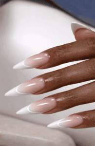 Long almond nails with soft nude to white French ombre gradient, seamless blend with glossy finish and clean modern bridal nail aesthetic