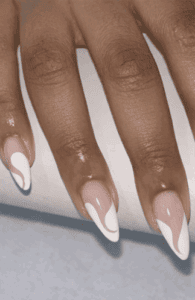 Almond-shaped nails with nude base and flowing white swirl accents, glossy finish with soft abstract design and elegant modern nail look