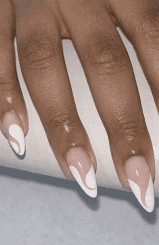 Almond-shaped nails with nude base and flowing white swirl accents, glossy finish with soft abstract design and elegant modern nail look