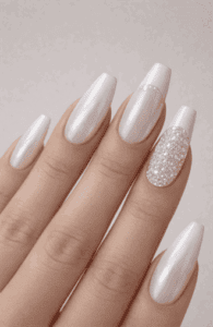 Long coffin nails with white pearl chrome finish and crystal accent nail, high-shine iridescent glow with luxury statement manicure style