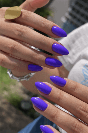 Royal purple almond nails with glossy finish, bold solid color manicure on long nails