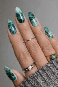 Deep emerald green marble almond nails with glossy finish, natural stone effect nail design on long elegant manicure