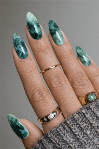 Emerald green marble almond nails with glossy finish, deep stone-inspired nail design on long elegant manicure
