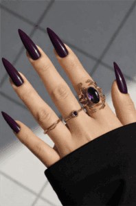 Deep plum stiletto nails with glossy finish, dark purple long pointed nail design