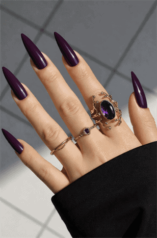 Deep plum stiletto nails with glossy finish, dark purple long pointed nail design