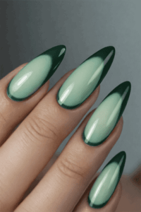 Green aura almond nails with glossy ombre fade from pale sage center to deep emerald edges, modern gradient manicure