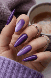 Purple ombre stiletto nails with glossy finish, gradient violet nail design on long pointed nails