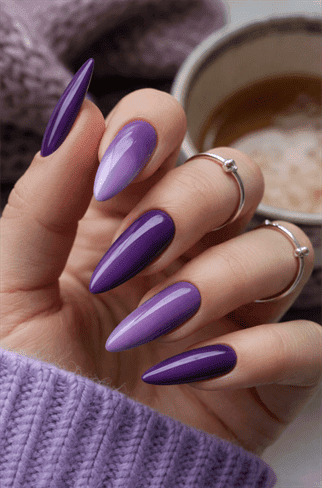 Purple ombre stiletto nails with glossy finish, gradient violet nail design on long pointed nails