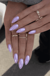 Light lavender chrome almond nails with glossy metallic finish, long iridescent purple manicure design