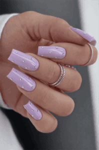 Lilac rhinestone coffin nails with glossy finish, pastel purple nail design with crystal accents on long nails
