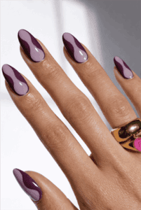 Mauve and plum abstract almond nails with glossy finish, two-tone wave nail design on long manicure