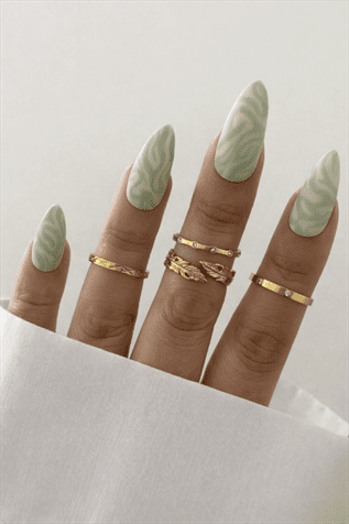 Mint green swirl almond nails with glossy finish, soft marble-inspired nail design on long elegant manicure