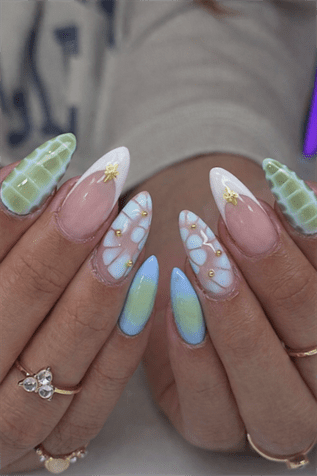 Pastel aura almond nails with blue and green ombre, 3D textured nail art, gold accents and glossy finish on long nails