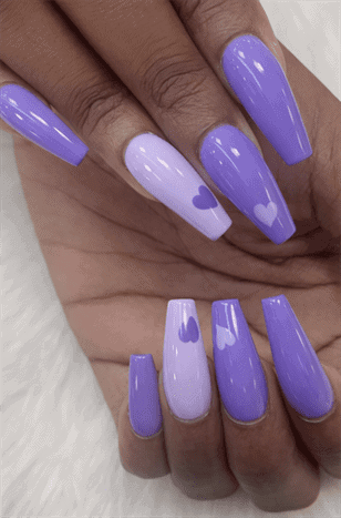Purple ombre coffin nails with heart accents, glossy long acrylic nails with lavender gradient design