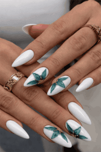 Glossy white almond nails with teal floral nail art and gold accents, elegant long manicure with detailed flower design