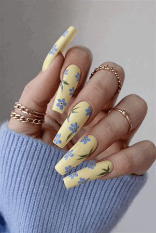Yellow floral coffin nails with blue flower design, glossy long acrylic nails with spring nail art