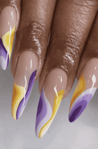 Yellow and purple swirl almond nails with glossy nude base, abstract wave nail design on long manicure