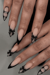 Black bow French tip almond nails with nude base, glossy coquette nail design with 3D bow accents