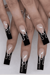 Black flame French tip coffin nails with nude base, glossy long acrylic nails with white flame outline design