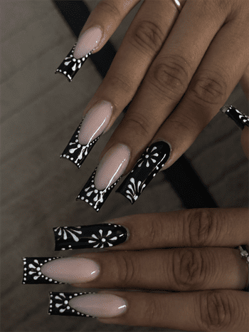Black floral French tip coffin nails with nude base, glossy monochrome flower nail design on long acrylic nails