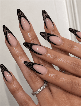 Black lace French tip stiletto nails with nude base, elegant gothic nail design with glossy finish