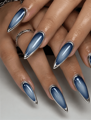 Blue chrome aura stiletto nails with silver metallic outline, glossy gradient nail design on long pointed nails