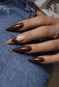 Chocolate brown almond nails with glossy finish and nude accent nail with heart design, elegant neutral manicure