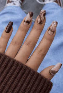 Brown marble swirl nails with glossy finish, mixed neutral nail design with chocolate and beige tones