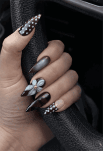 Chocolate brown mix and match stiletto nails with polka dots, chrome accent and 3D flower nail art