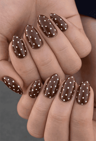 Chocolate brown polka dot almond nails with glossy finish, white dot nail design on long nails