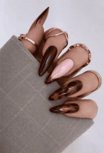 Chocolate brown and tortoiseshell stiletto nails with glossy finish, mixed design with nude accent nail
