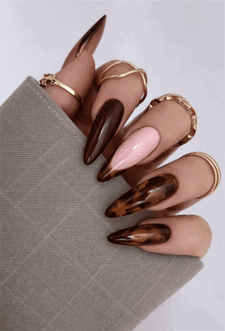 Chocolate brown and tortoiseshell stiletto nails with glossy finish, mixed design with nude accent nail