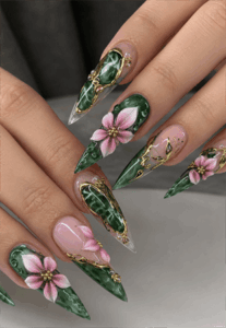 Emerald marble stiletto nails with pink 3D floral accents, luxury gemstone nail design featuring gold detailing and glossy finish